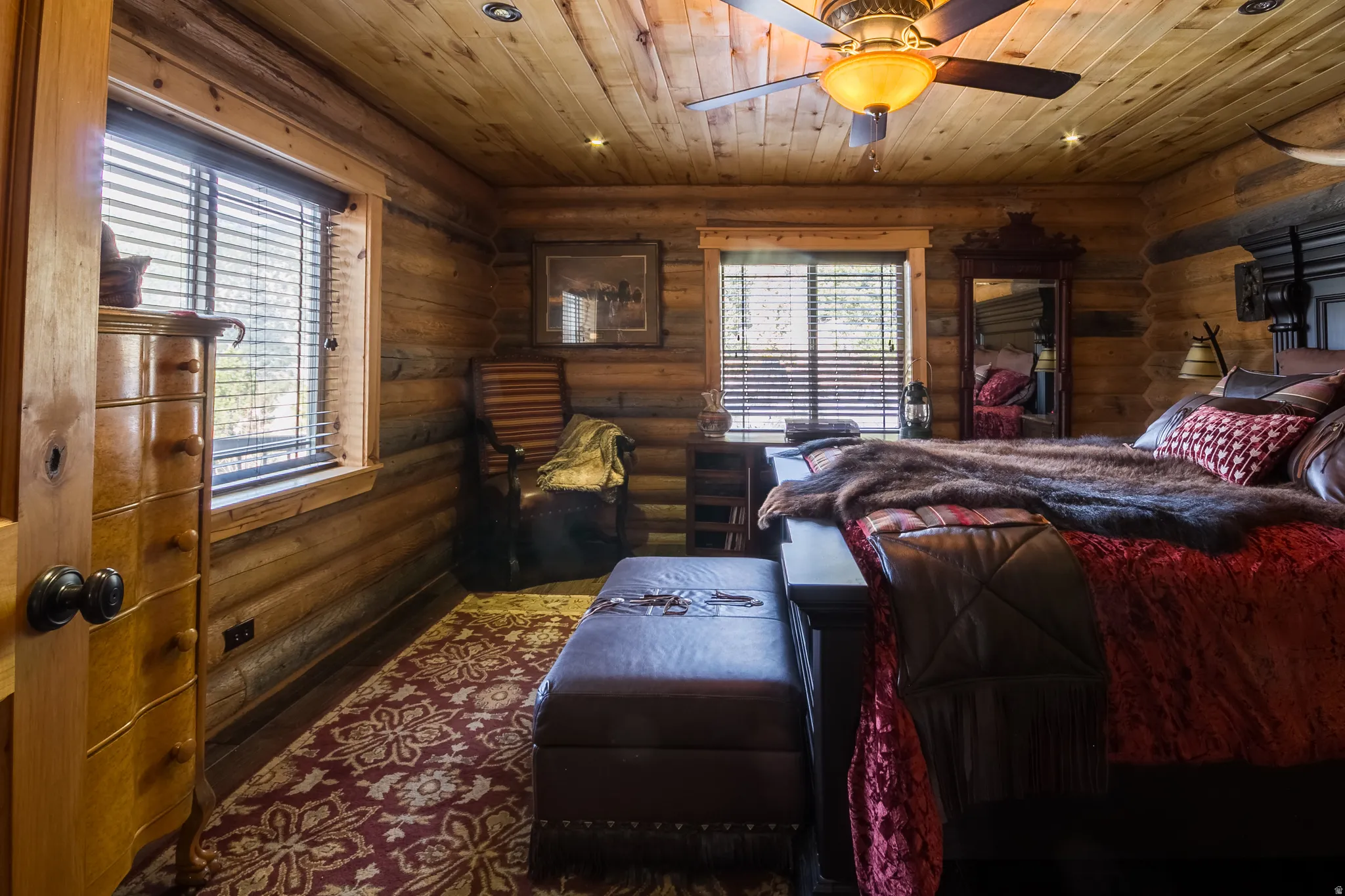 Bedroom with wooden ceiling, ceiling fan, rustic walls, and recessed lighting
