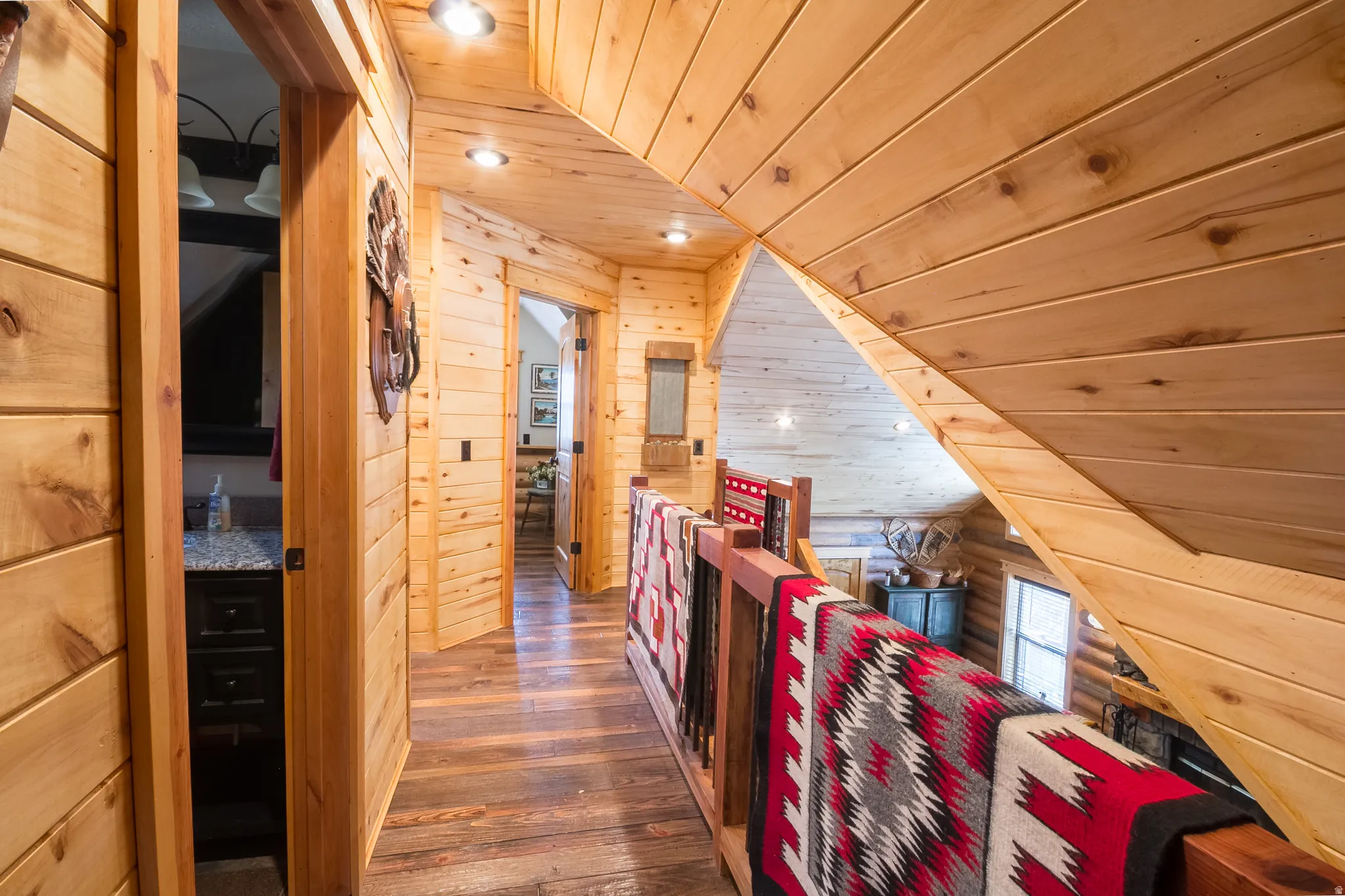 Corridor featuring wooden ceiling, wood walls, dark wood-style flooring, and recessed lighting