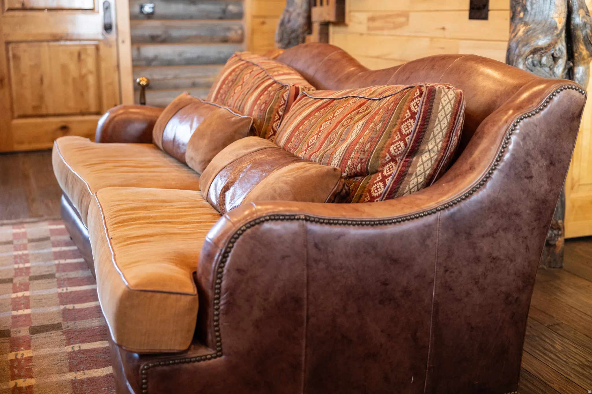 Living area featuring dark wood-style floors and rustic walls