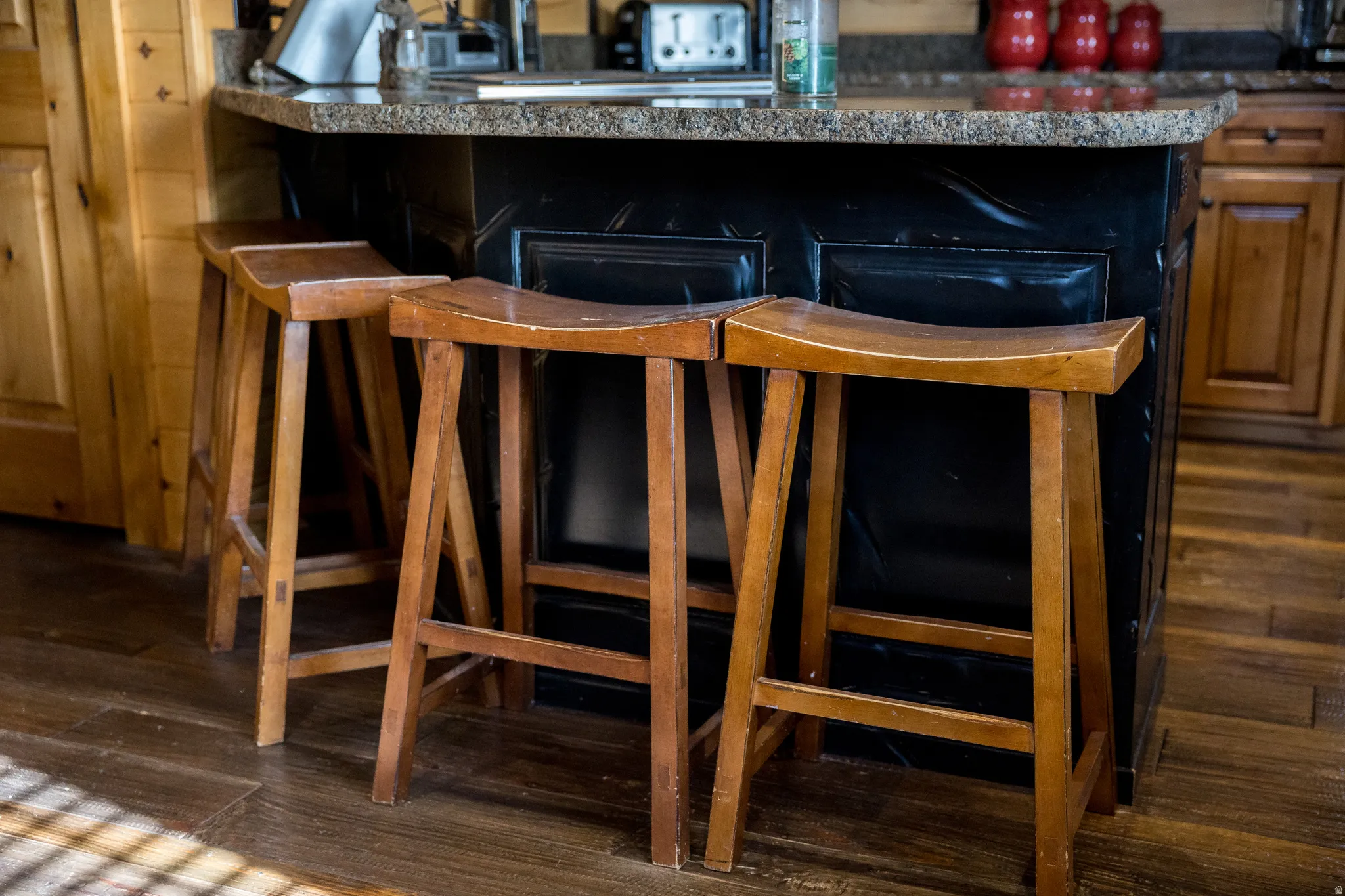 Bar area featuring dark wood-style flooring