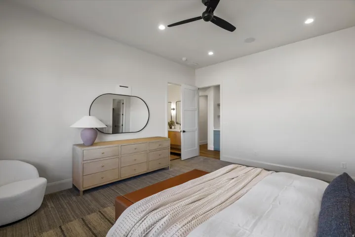 Bedroom with ceiling fan, connected bathroom, and recessed lighting