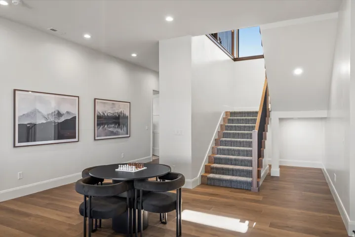 Dining space with recessed lighting and dark wood-style flooring