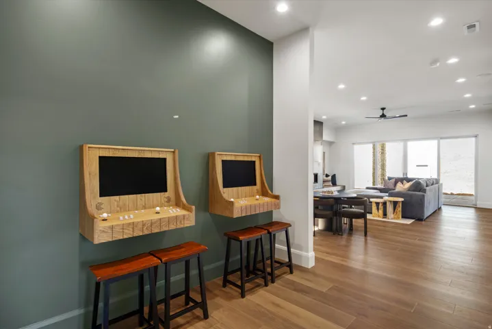 Interior space with wood finished floors, ceiling fan, and recessed lighting