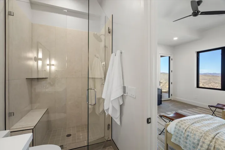 Ensuite bathroom with a shower stall, ceiling fan, recessed lighting, and vanity