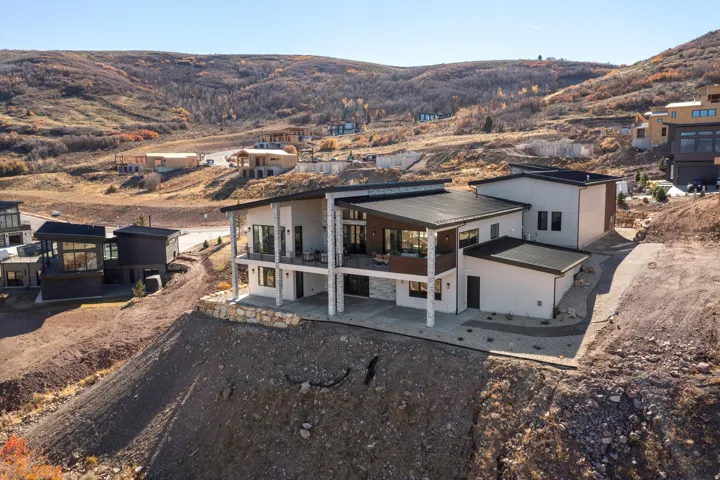 Rear view of house with a patio area, a metal roof, and a mountain view