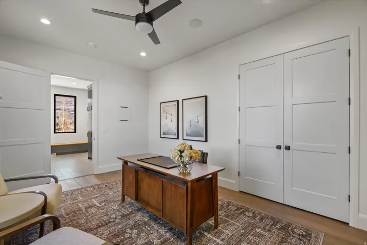 Office space with wood finished floors, recessed lighting, and a ceiling fan