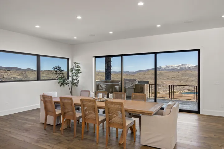 Dining area with dark wood-type flooring, a mountain view, recessed lighting, and plenty of natural light