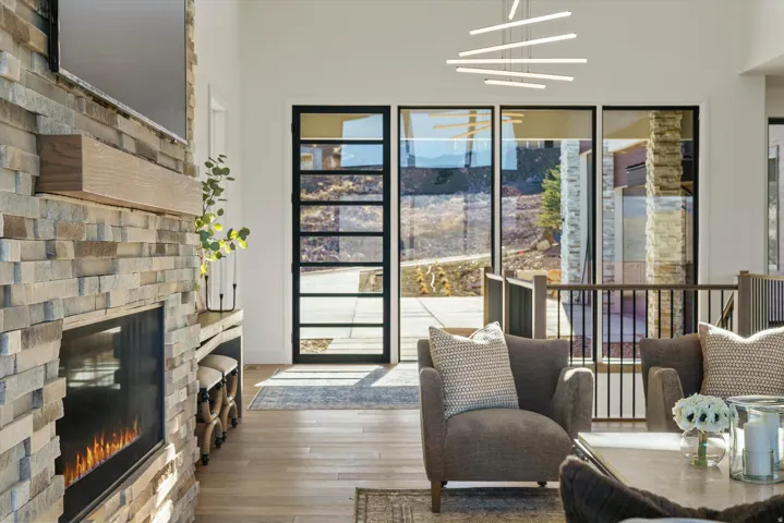 Living area with wood-type flooring and a glass covered fireplace