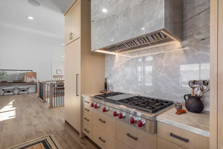 Kitchen with stainless steel gas stovetop, decorative backsplash, light wood-style flooring, recessed lighting, and light wood finish cabinetry