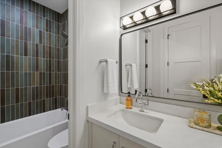 Bathroom with vanity and bathing tub / shower combination