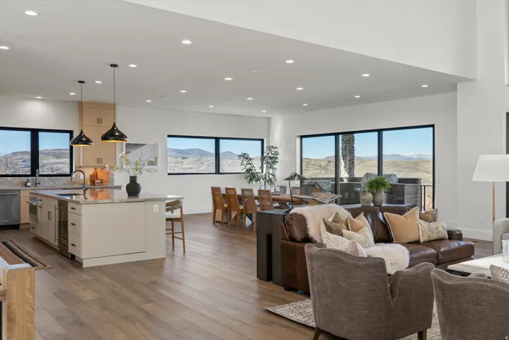Living room featuring light wood-style floors, recessed lighting, and a mountain view