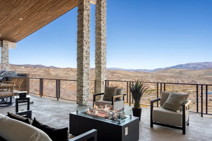 View of patio / terrace featuring an outdoor living space with a fire pit, a mountain view, and grilling area