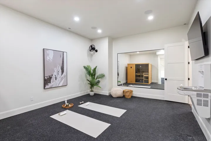 Exercise area with recessed lighting and carpet flooring