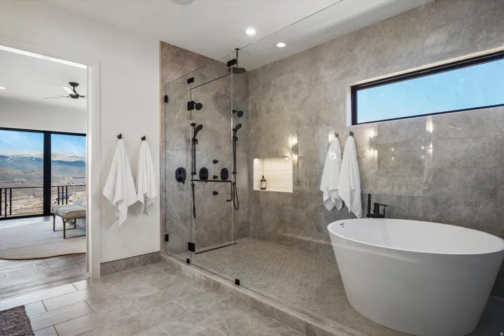Bathroom with a mountain view, a soaking tub, a shower stall, and recessed lighting
