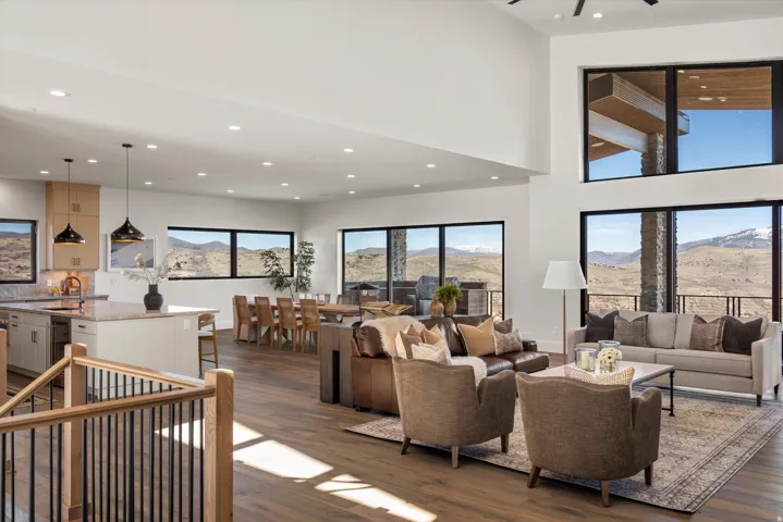 Living area with dark wood finished floors, a high ceiling, recessed lighting, and a mountain view