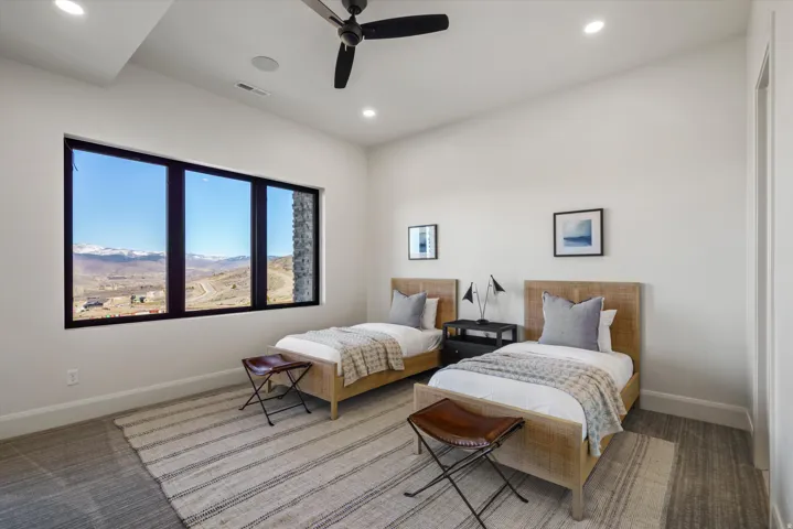 Bedroom with a ceiling fan, light colored carpet, recessed lighting, and a mountain view