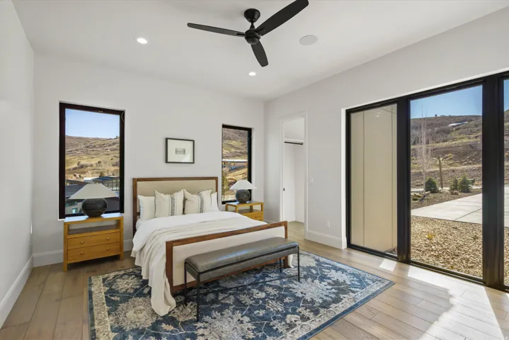 Bedroom with light wood-type flooring, recessed lighting, ceiling fan, and access to outside