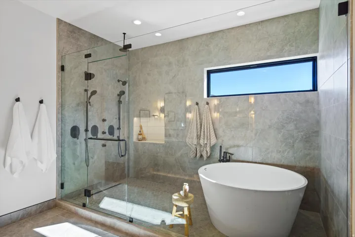 Bathroom featuring a freestanding tub, a shower stall, and recessed lighting