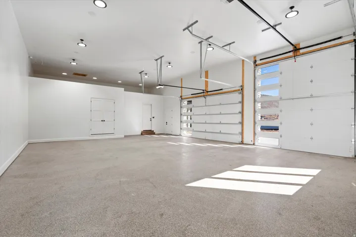 Garage with baseboards and recessed lighting