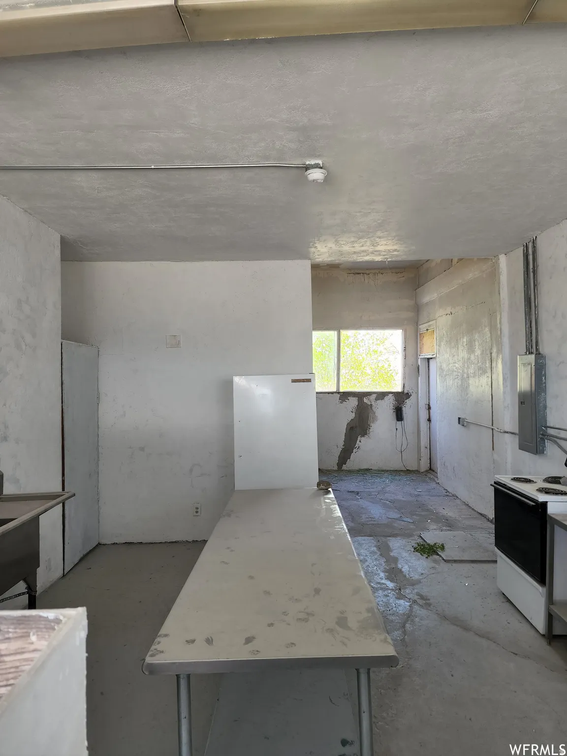 Misc room featuring concrete floors and electric panel