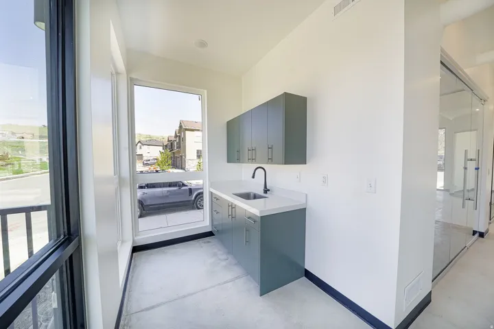 Bar area featuring concrete flooring, healthy amount of natural light, and modern cabinets