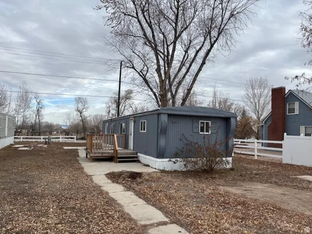 View of home's exterior featuring a wooden deck