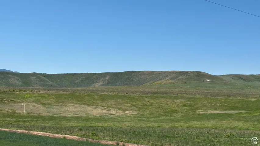 View of mountain backdrop featuring rural landscape