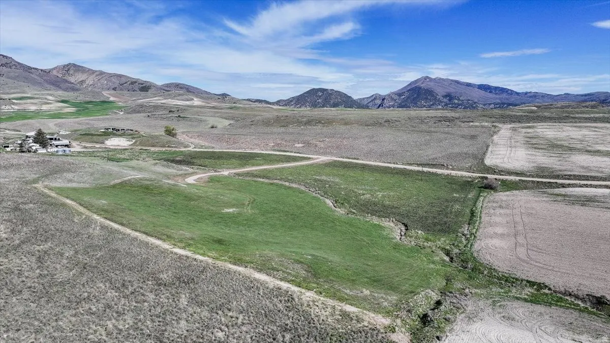 View of mountain backdrop with rural landscape