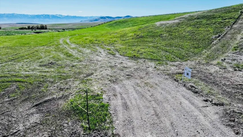 Overview of rural landscape featuring a mountainous background