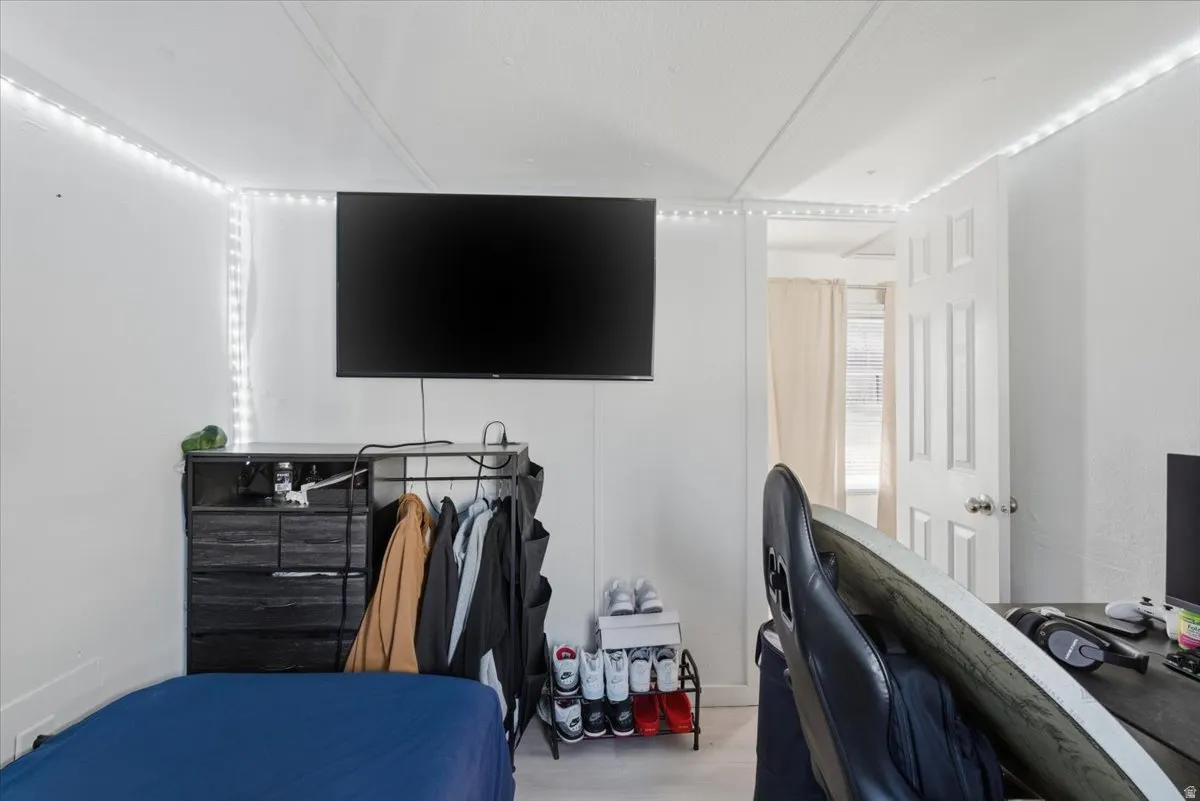 Bedroom with a desk and wood finished floors