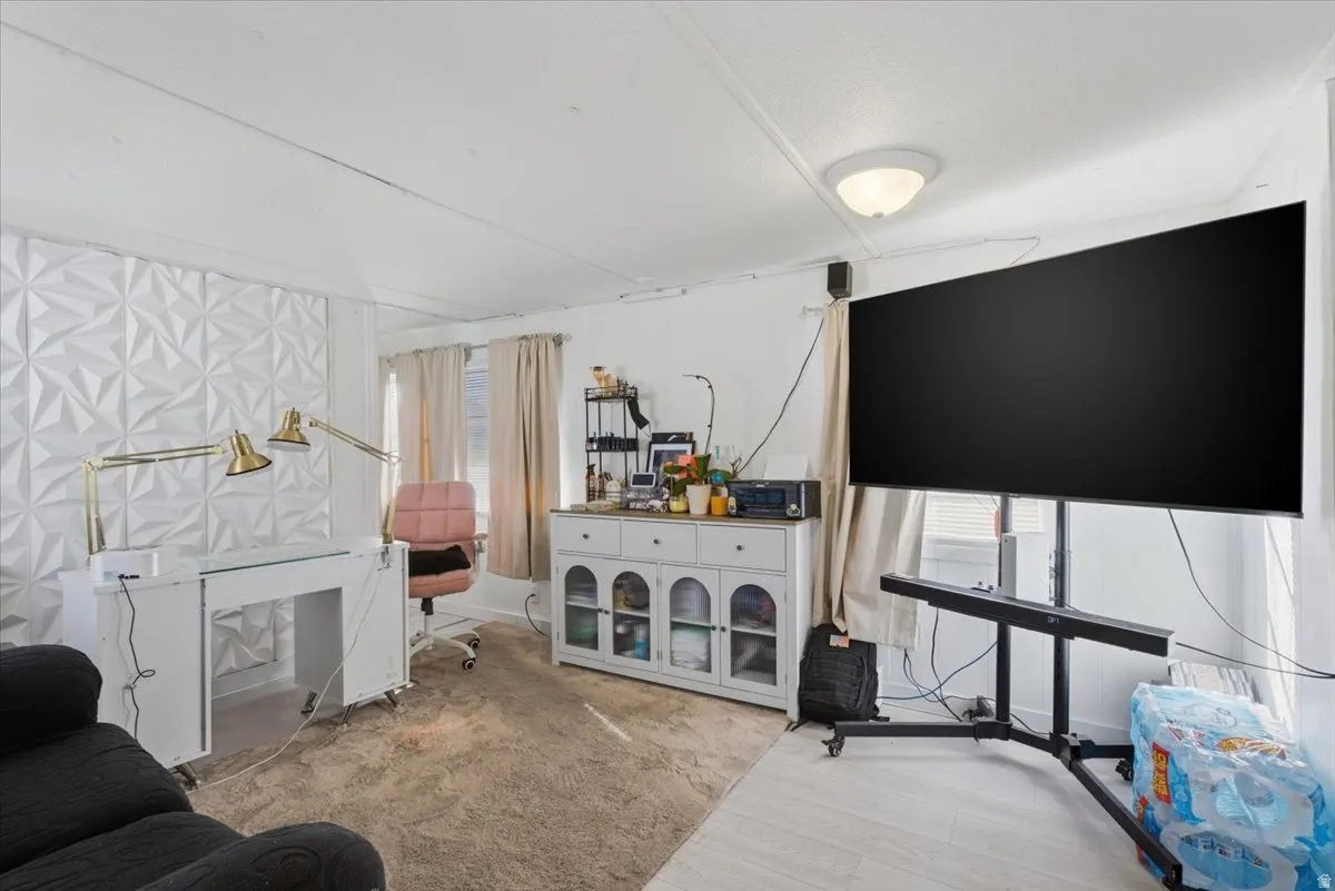 Living area with wood finished floors and baseboards