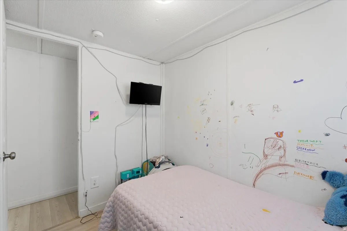 Bedroom featuring wood finished floors and baseboards