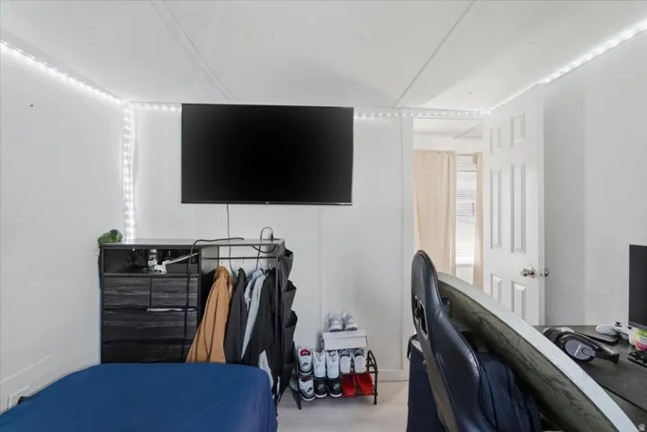 Bedroom with a desk and wood finished floors