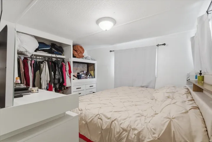 Bedroom with a closet and a textured ceiling