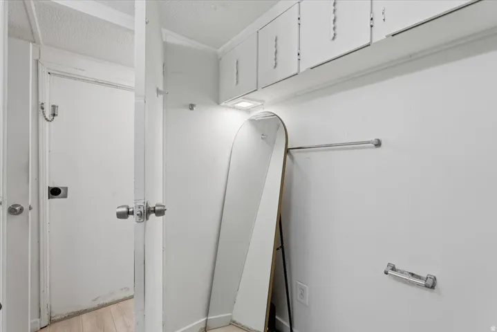Bathroom featuring a textured ceiling and light wood-type flooring