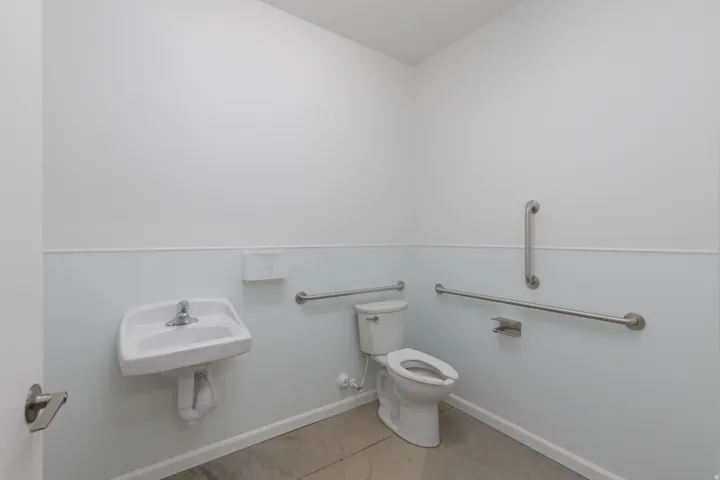 Bathroom with toilet and baseboards