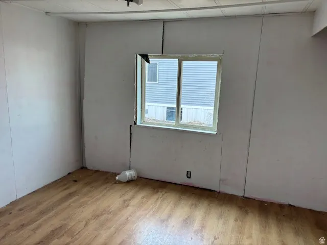 Unfurnished room featuring light wood-style flooring