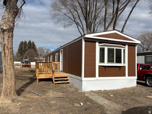 View of side of property with a deck