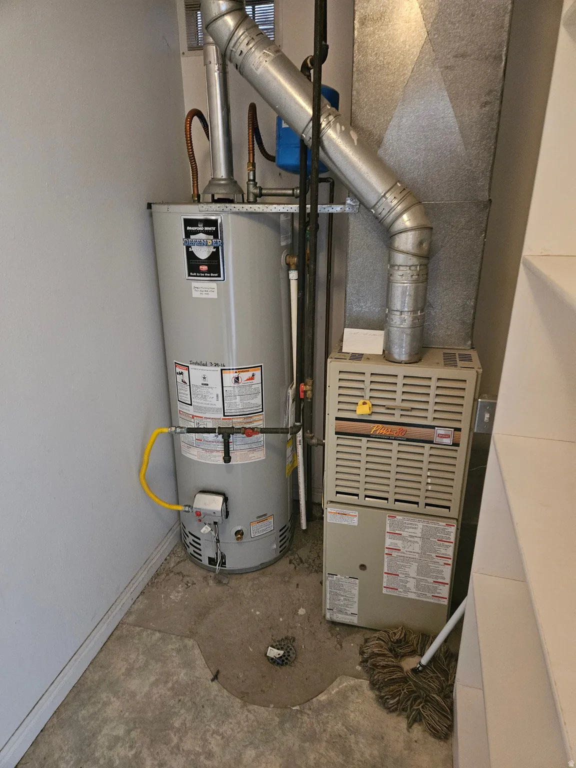 Utility room with gas water heater and heating unit