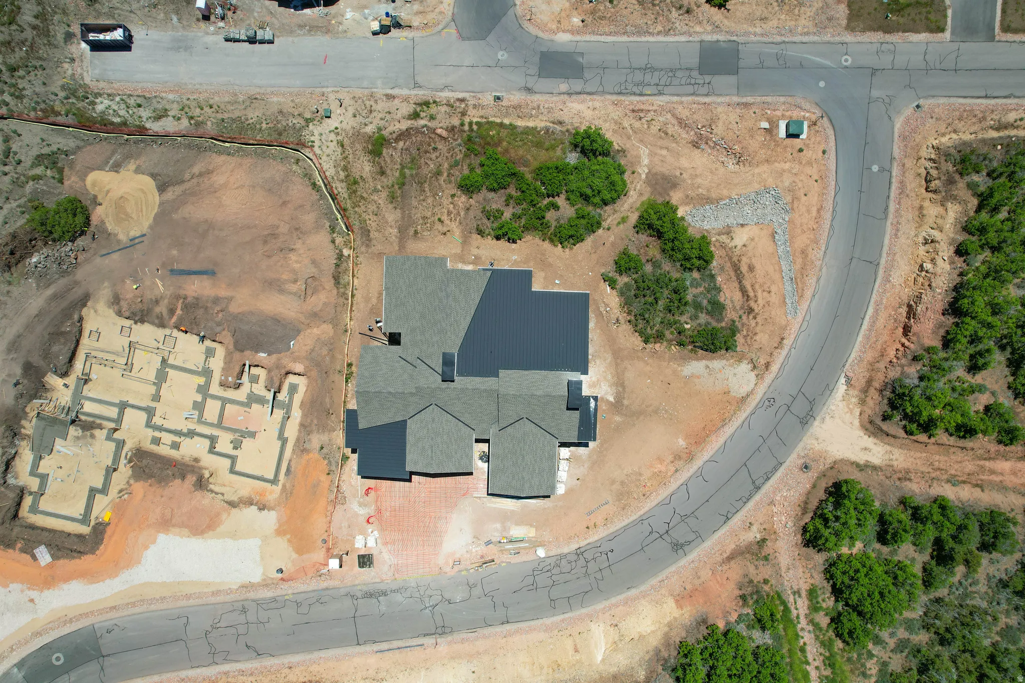 New construction home featuring a gray shingle roof and a gray metal roof section
