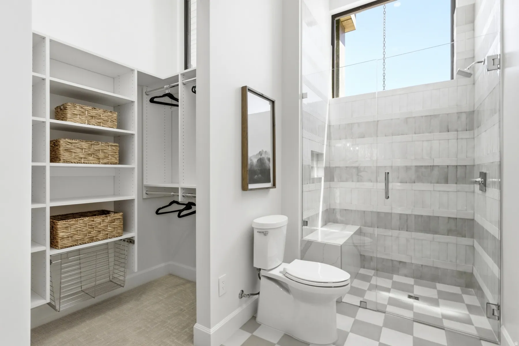 Walk-in closet with built-in shelving, hanging rods, and a pull-out wire hamper