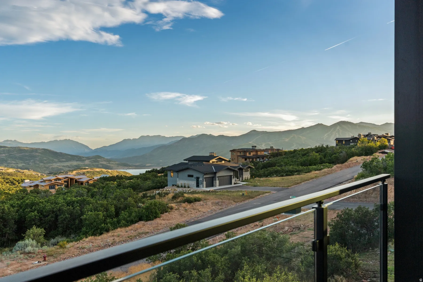 Glass panel railing with a metal top rail
