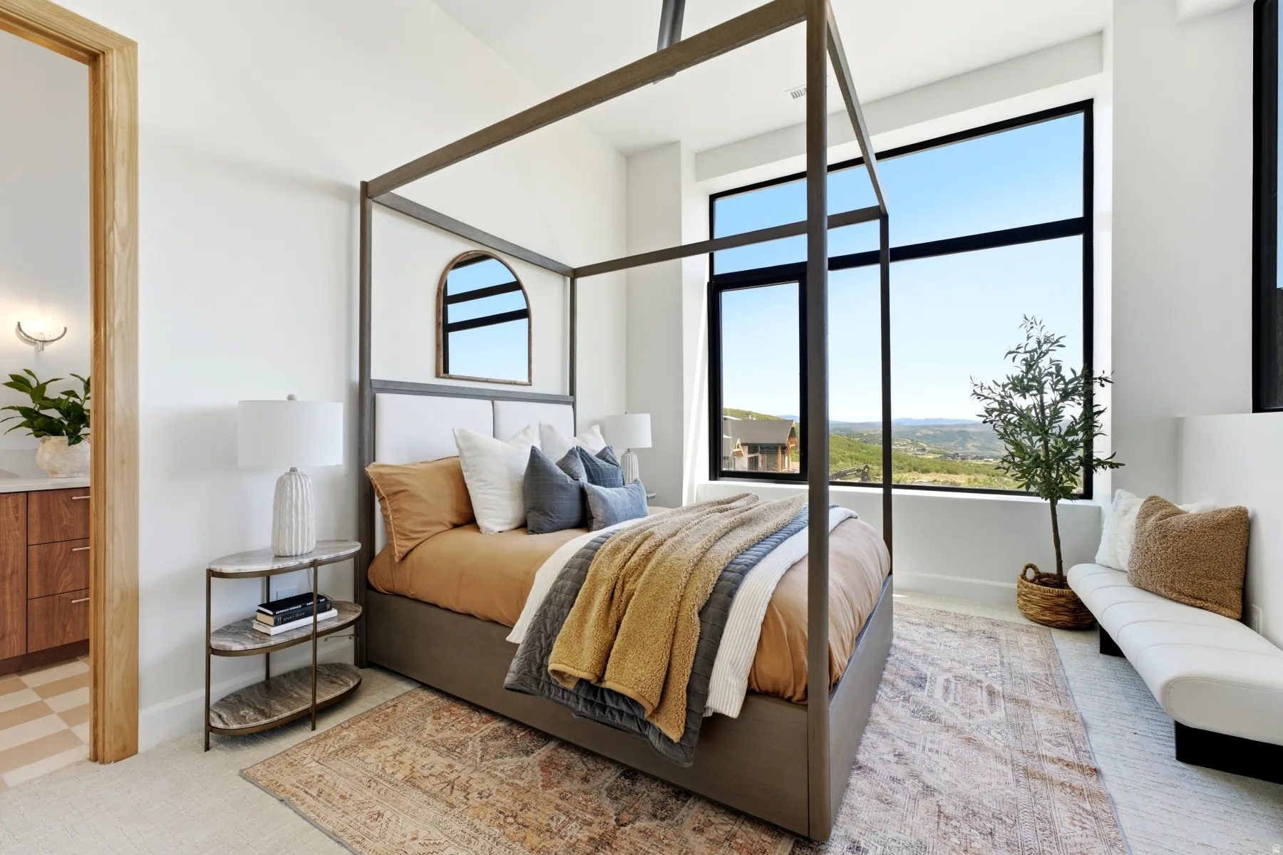 Bedroom with expansive floor-to-ceiling windows, white walls, and light-toned carpeting