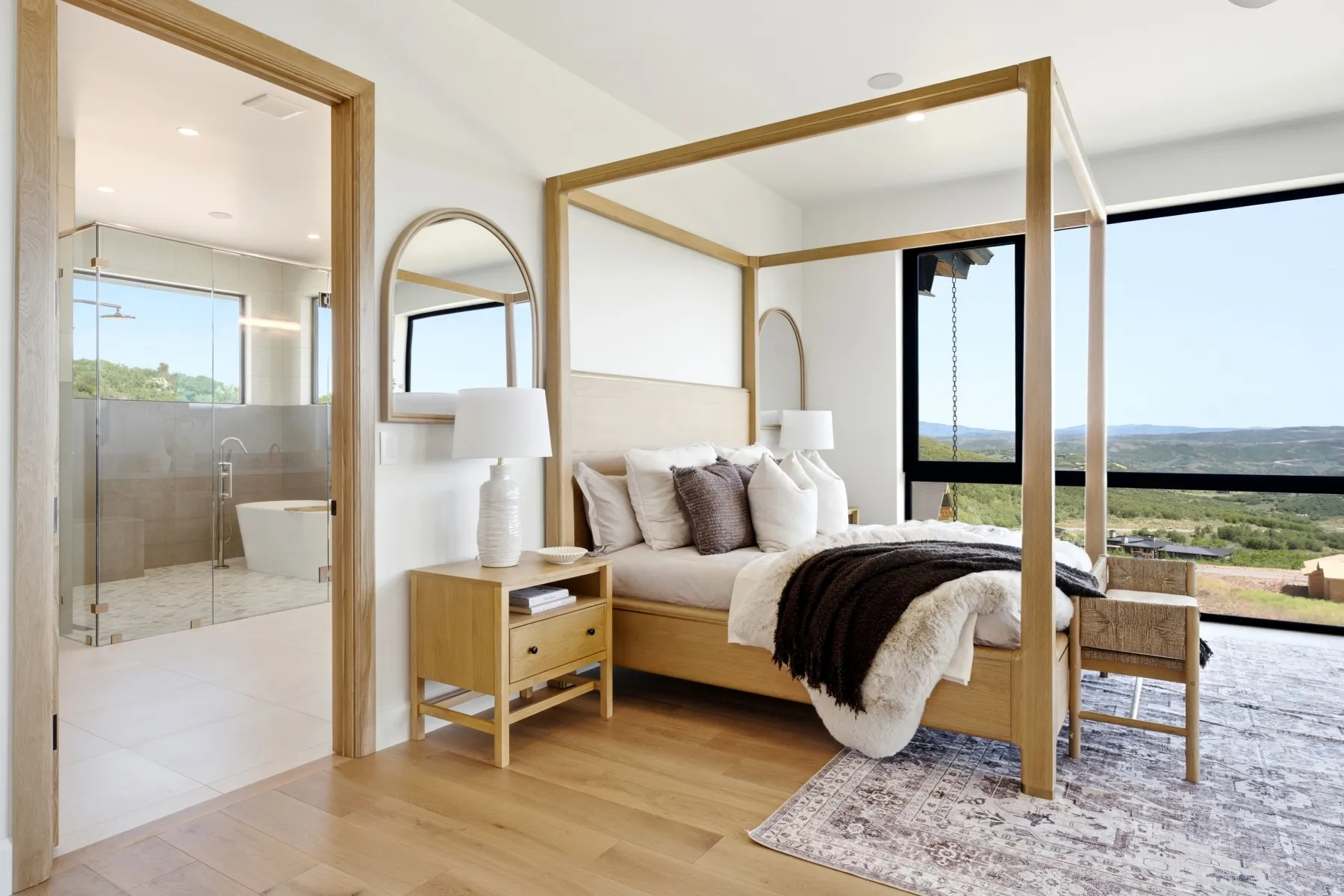 Bedroom with wood-finish flooring and expansive windows