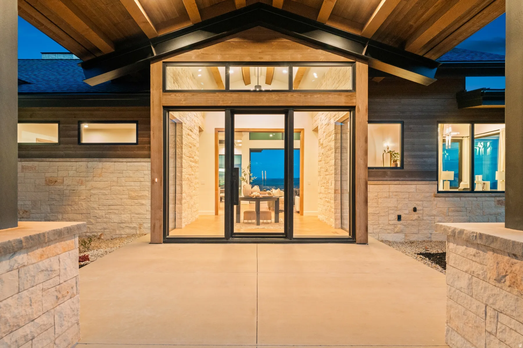 Modern exterior with stacked stone and wood-paneled siding