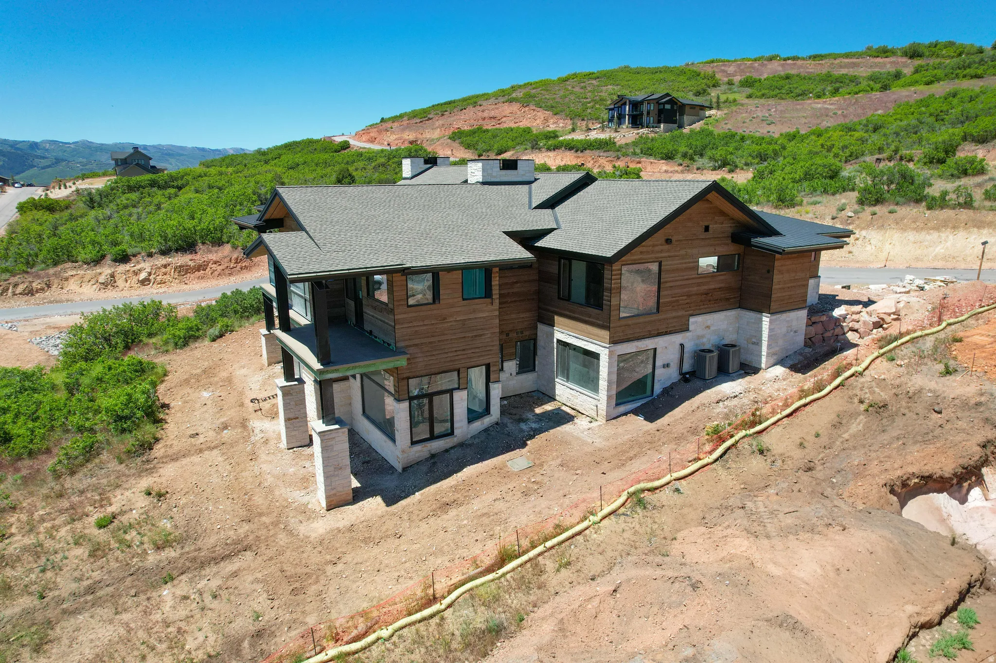 Modern mountain home featuring extensive wood siding and stone accents