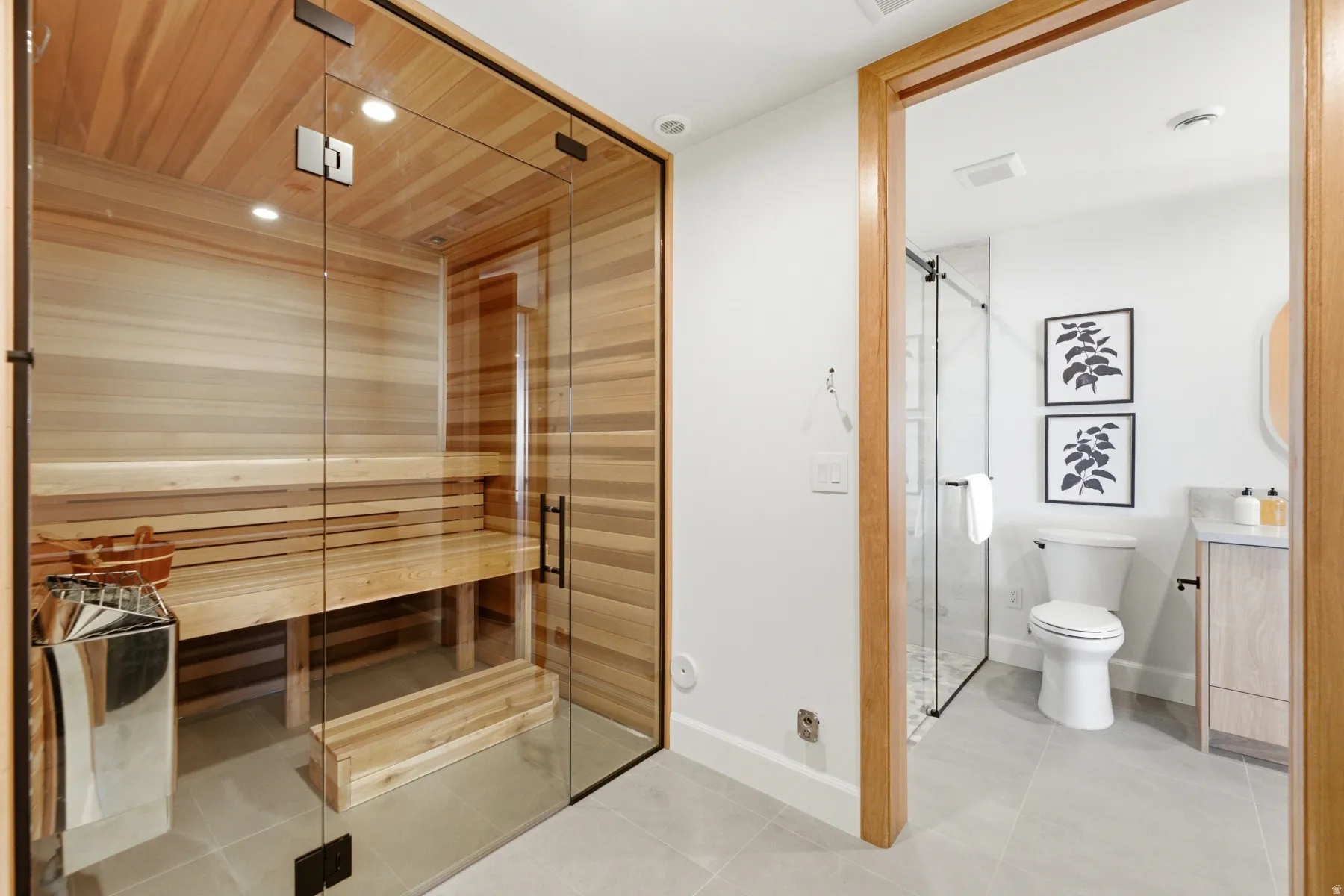 Glass-enclosed sauna with wood-paneled interior and built-in benches
