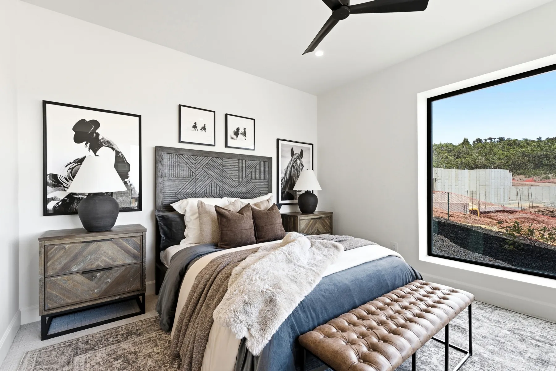 White walls with a recessed light and a black ceiling fan