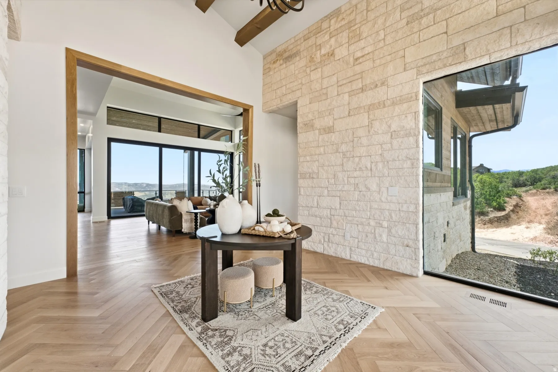 Foyer featuring a stone accent wall and herringbone wood-finish flooring