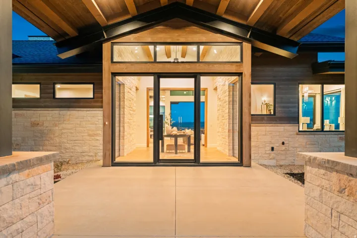 Modern exterior with stacked stone and wood-paneled siding